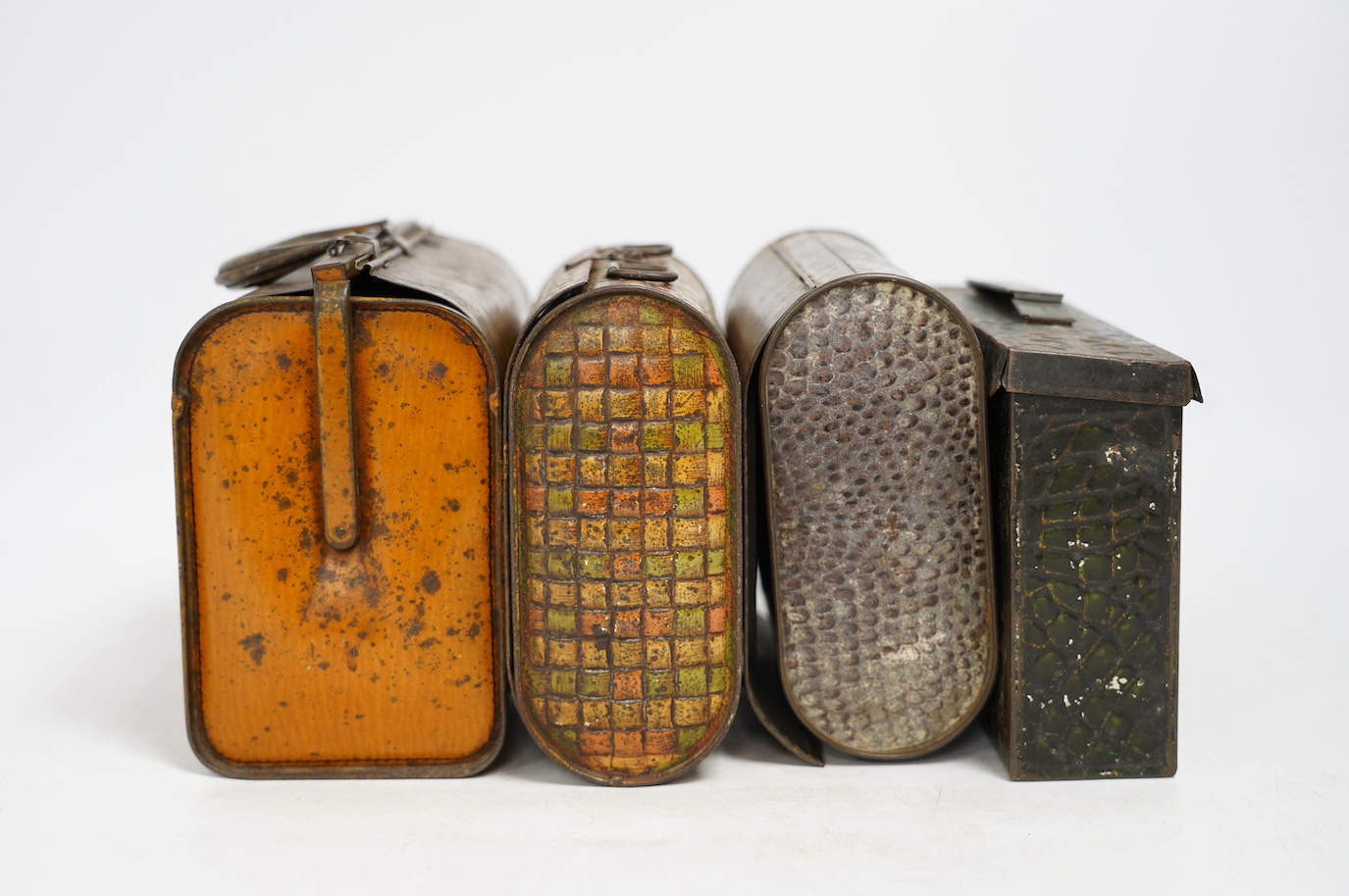Four biscuit tins: an early 20th century Huntley & Palmers novelty biscuit tin, modelled as a Gladstone bag, 20cm wide, 16cm high, two other Huntley & Palmers tins and a Peek Frean novelty biscuit tin. Condition - fair
